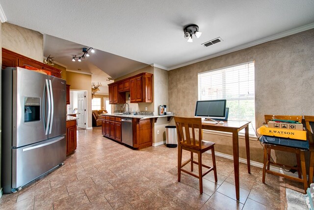 8625 Harvard Ave, Odessa, TX 79765 - kitchen featuring stainless steel appliances, healthy amount of natural light, crown molding, a peninsula, and a desk