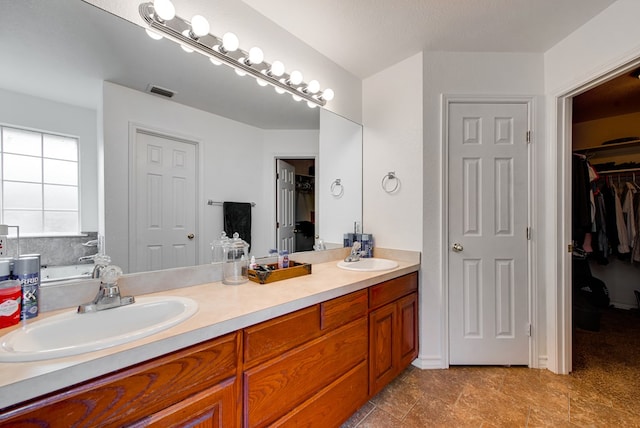 8625 Harvard Ave, Odessa, TX 79765 - full bathroom with double vanity and a walk in closet
