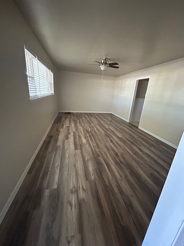 1712 Nabors Ln, Odessa, TX 79761 - unfurnished bedroom with baseboards, dark wood finished floors, and a ceiling fan