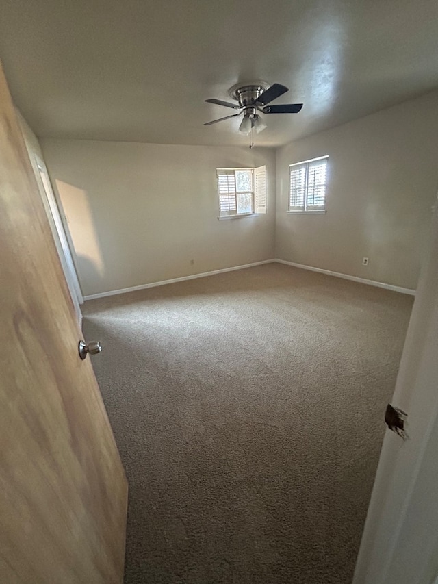 1712 Nabors Ln, Odessa, TX 79761 - spare room featuring carpet floors, ceiling fan, and baseboards