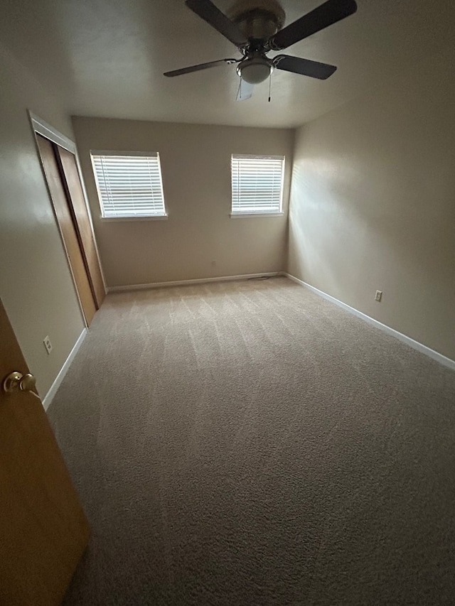 1712 Nabors Ln, Odessa, TX 79761 - unfurnished room with a ceiling fan, baseboards, and light carpet
