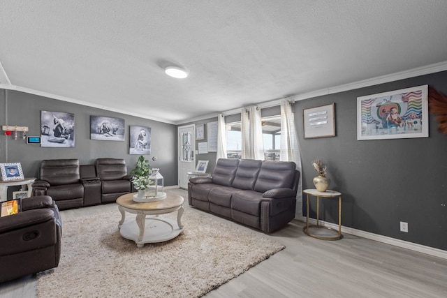 living area featuring baseboards, crown molding, and wood finished floors