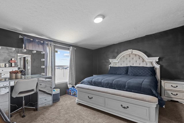 bedroom featuring a textured ceiling and carpet flooring