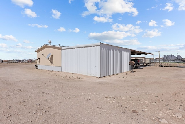 view of outbuilding with a carport and an outbuilding