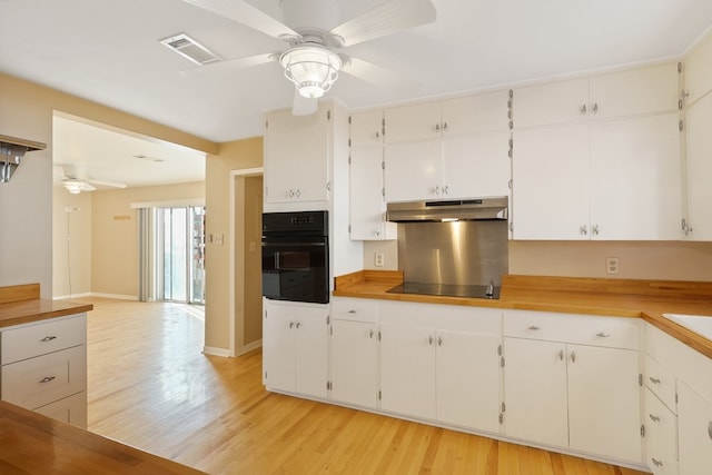 401 E Sul Ross Ave, Alpine, TX 79830 - kitchen featuring black appliances, a ceiling fan, under cabinet range hood, light wood-type flooring, and white cabinets