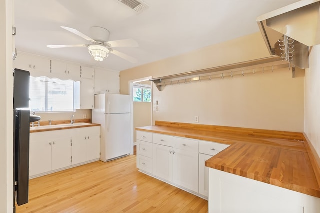 401 E Sul Ross Ave, Alpine, TX 79830 - kitchen with freestanding refrigerator, white cabinetry, a ceiling fan, light wood-style flooring, and a sink