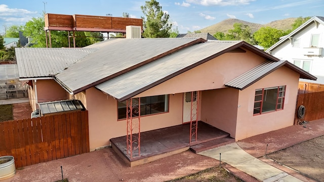 401 E Sul Ross Ave, Alpine, TX 79830 - back of house featuring stucco siding, metal roof, a mountain view, and a patio area