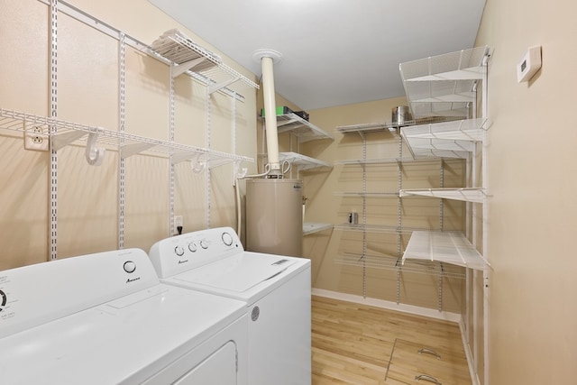 401 E Sul Ross Ave, Alpine, TX 79830 - washroom featuring washing machine and clothes dryer, water heater, light wood-style flooring, and baseboards