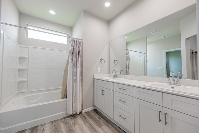 6205 Globe Life Ct, Odessa, TX 79762 - bathroom with shower / bath combo, double vanity, wood finished floors, and recessed lighting