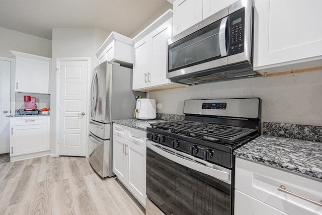 6205 Globe Life Ct, Odessa, TX 79762 - kitchen with appliances with stainless steel finishes, light stone countertops, and white cabinets