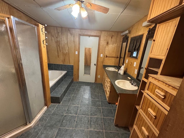 101 Stage Coach Pass, Fort Davis, TX 79734 - full bathroom with a shower stall, a garden tub, a ceiling fan, double vanity, and tile patterned flooring
