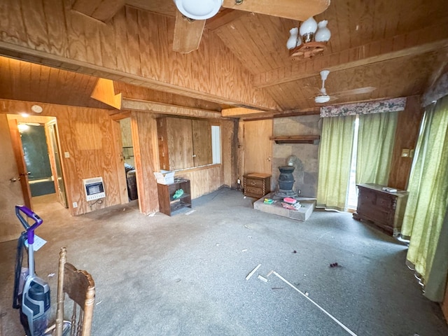 101 Stage Coach Pass, Fort Davis, TX 79734 - unfurnished living room with wood walls, wooden ceiling, heating unit, lofted ceiling, and a wood stove