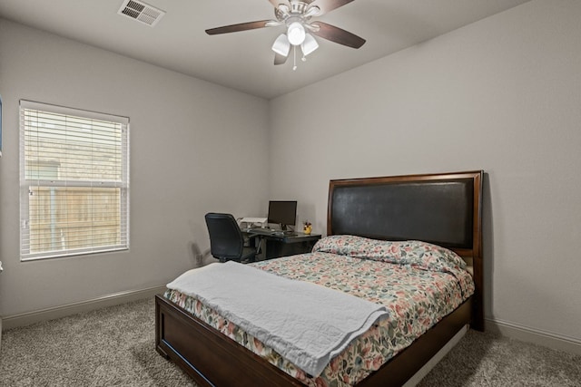 carpeted bedroom with baseboards, visible vents, and a ceiling fan