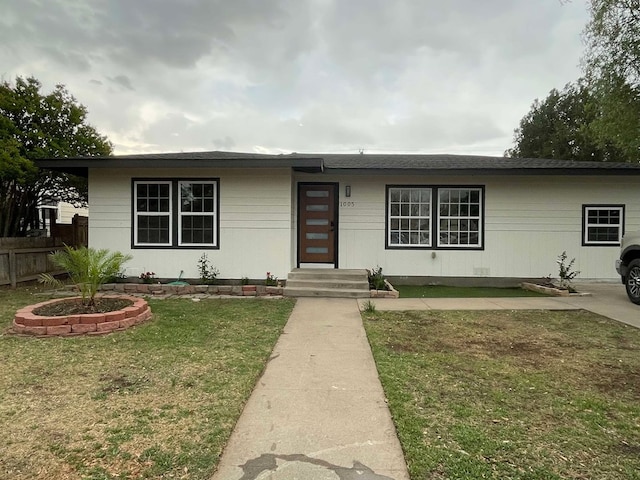 single story home with fence and a front lawn