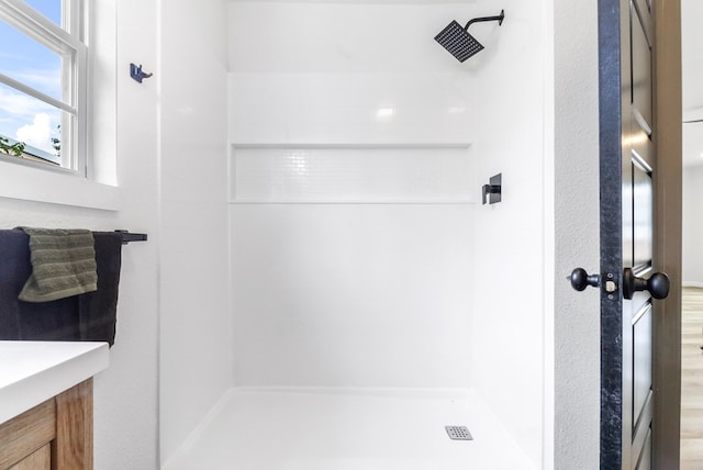 full bath featuring tiled shower