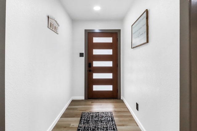 doorway to outside featuring light wood-style floors and baseboards