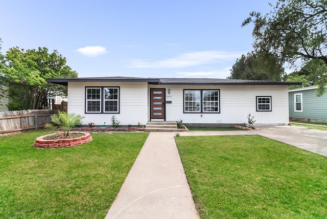 ranch-style house with fence and a front yard