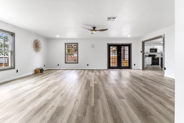 unfurnished living room with ceiling fan, recessed lighting, baseboards, light wood-type flooring, and visible vents