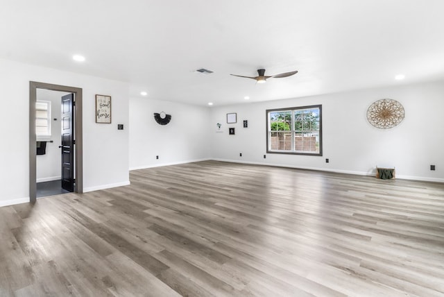 unfurnished living room with recessed lighting, a ceiling fan, visible vents, and wood finished floors