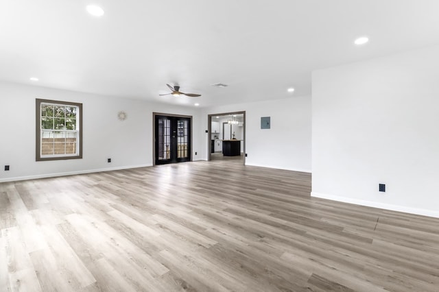 unfurnished living room with baseboards, a ceiling fan, recessed lighting, and wood finished floors