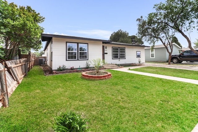 ranch-style house featuring central AC, a front lawn, and fence