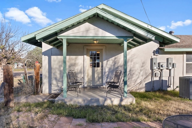 308 N 10th St, Alpine, TX 79830 - rear view of property featuring stucco siding, cooling unit, and fence
