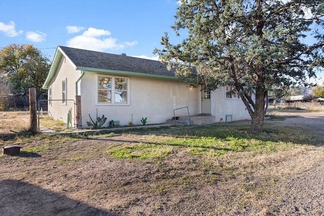 308 N 10th St, Alpine, TX 79830 - view of front of home with stucco siding and roof with shingles