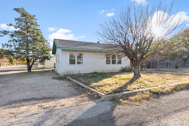 308 N 10th St, Alpine, TX 79830 - view of home's exterior with stucco siding and fence