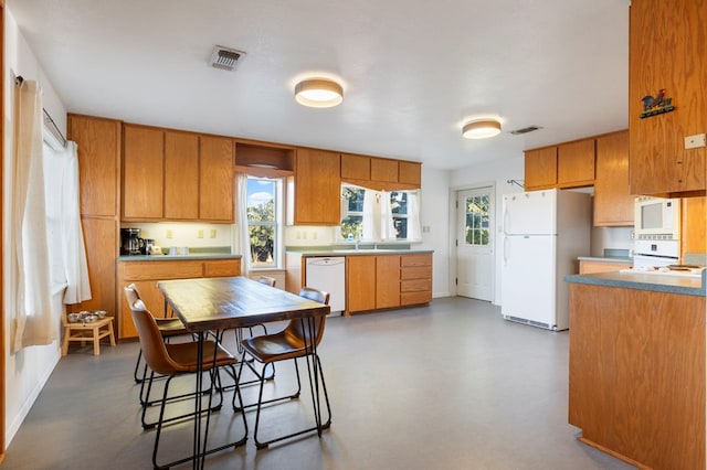 308 N 10th St, Alpine, TX 79830 - kitchen with white appliances, a sink, and brown cabinetry