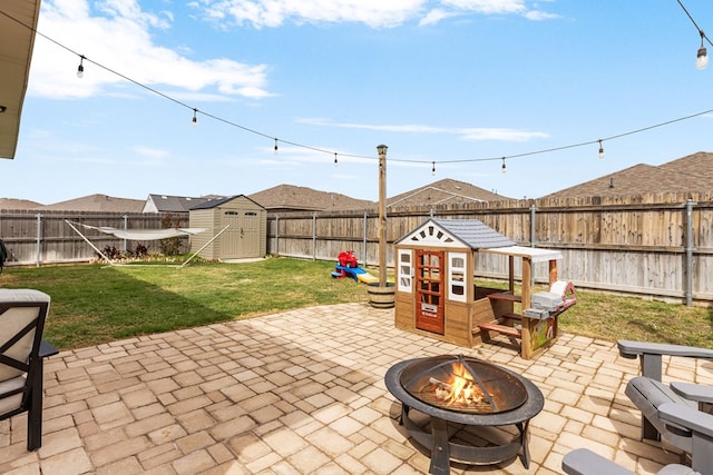 1215 E 93rd St, Odessa, TX 79765 - view of patio / terrace featuring an outdoor fire pit, a storage shed, and an outdoor structure