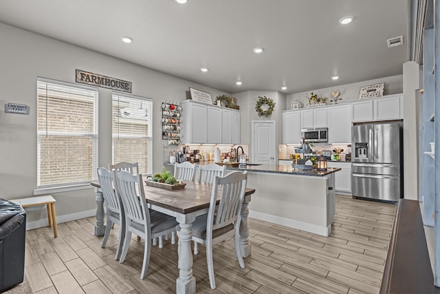 1215 E 93rd St, Odessa, TX 79765 - dining space with wood tiled floors, recessed lighting, and baseboards