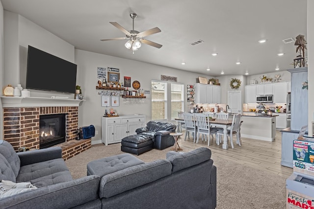 1215 E 93rd St, Odessa, TX 79765 - living area with a ceiling fan, recessed lighting, a fireplace, light wood finished floors, and baseboards