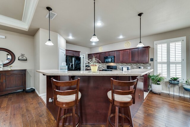 7302 Giotto St, Odessa, TX 79765 - kitchen featuring black appliances, dark wood finished floors, baseboards, decorative light fixtures, and crown molding