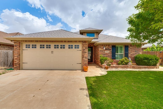 7302 Giotto St, Odessa, TX 79765 - view of front of property with brick siding, driveway, a garage, and a shingled roof