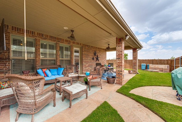 7302 Giotto St, Odessa, TX 79765 - fenced backyard featuring an outdoor hangout area, a patio area, and ceiling fan