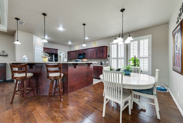 7302 Giotto St, Odessa, TX 79765 - dining room with dark wood finished floors, a chandelier, and recessed lighting