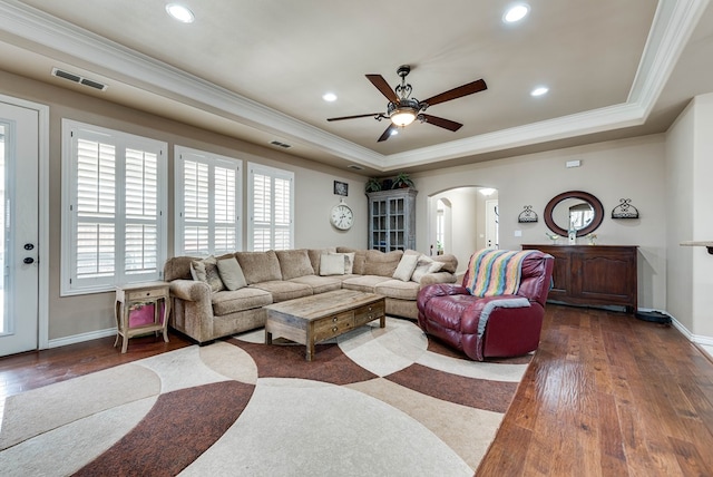 7302 Giotto St, Odessa, TX 79765 - living area featuring arched walkways, a tray ceiling, crown molding, dark wood-style flooring, and ceiling fan