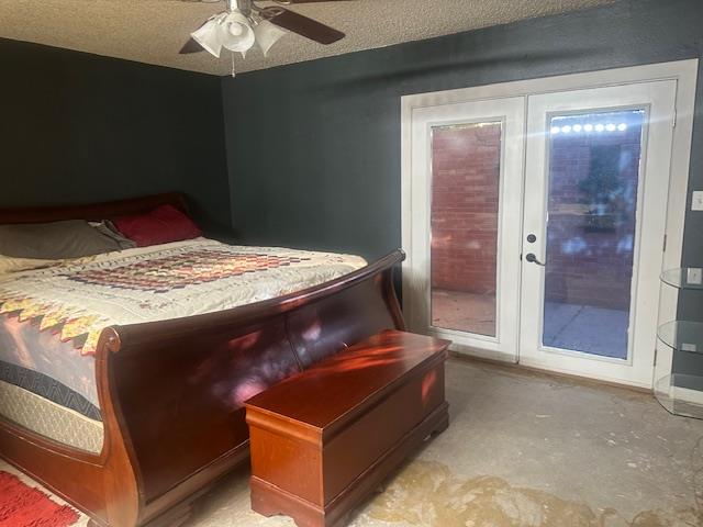 606 NW 14th St, Andrews, TX 79714 - bedroom with access to exterior, unfinished concrete floors, ceiling fan, and a textured ceiling