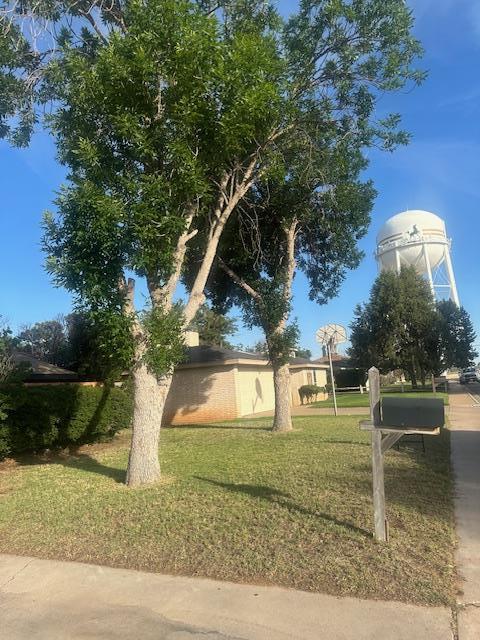 606 NW 14th St, Andrews, TX 79714 - view of property exterior with a yard