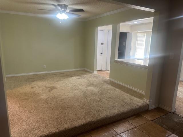 606 NW 14th St, Andrews, TX 79714 - spare room with crown molding, carpet, a ceiling fan, and a textured ceiling
