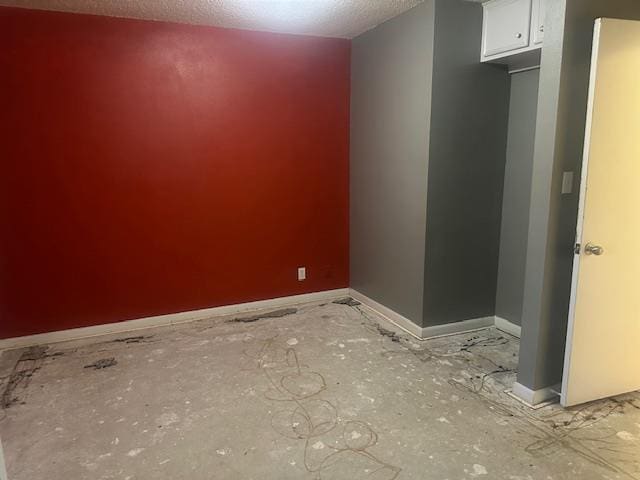 606 NW 14th St, Andrews, TX 79714 - unfurnished room featuring a textured ceiling and baseboards