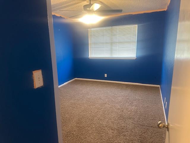 606 NW 14th St, Andrews, TX 79714 - carpeted spare room with ceiling fan and a textured ceiling