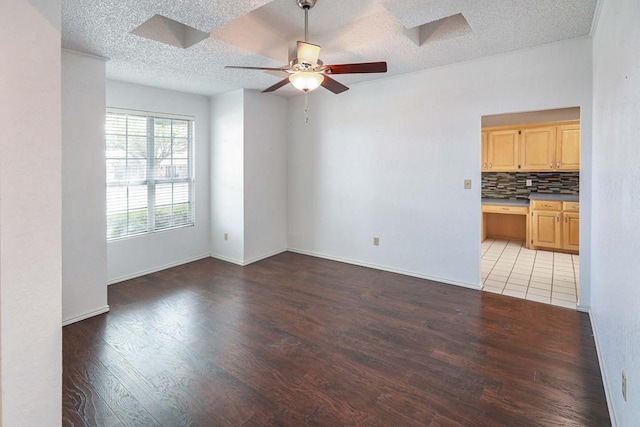 1203 S Nelson Ave, Monahans, TX 79756 - empty room featuring light wood finished floors, ceiling fan, a textured ceiling, and baseboards