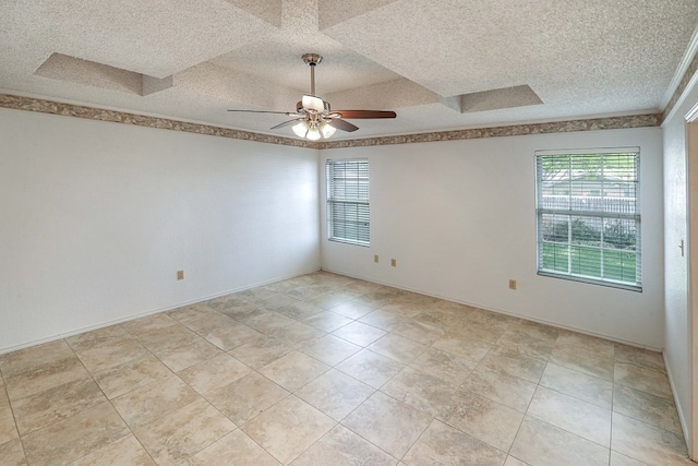 1203 S Nelson Ave, Monahans, TX 79756 - empty room featuring plenty of natural light, a ceiling fan, and a textured ceiling