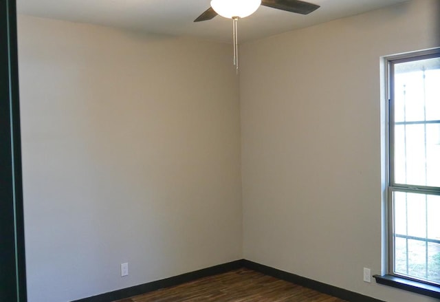 4603 N Tom Green Ave, Odessa, TX 79762 - unfurnished room featuring healthy amount of natural light, dark wood-style floors, and a ceiling fan