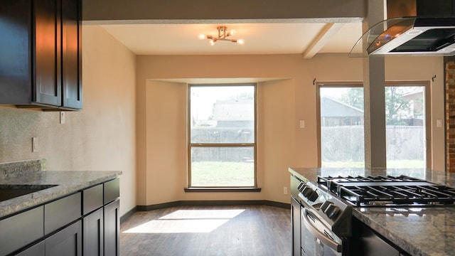 4603 N Tom Green Ave, Odessa, TX 79762 - kitchen with gas range, range hood, wood finished floors, dark stone counters, and beam ceiling