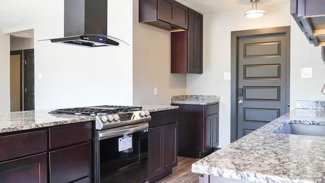 4603 N Tom Green Ave, Odessa, TX 79762 - kitchen with gas stove, island range hood, dark wood-style floors, light stone countertops, and dark brown cabinetry