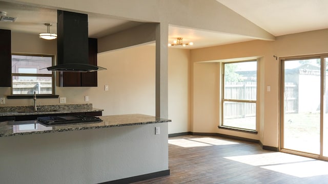 4603 N Tom Green Ave, Odessa, TX 79762 - kitchen featuring island exhaust hood, wood finished floors, dark stone countertops, black gas cooktop, and lofted ceiling