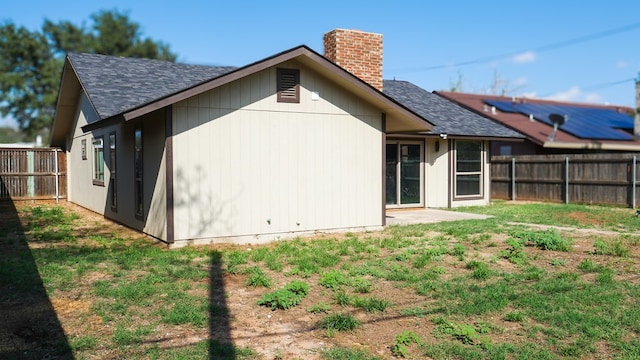 4603 N Tom Green Ave, Odessa, TX 79762 - back of property featuring a chimney, a fenced backyard, and roof with shingles