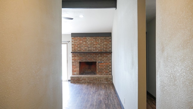 4603 N Tom Green Ave, Odessa, TX 79762 - unfurnished living room with wood finished floors, a textured wall, and a fireplace